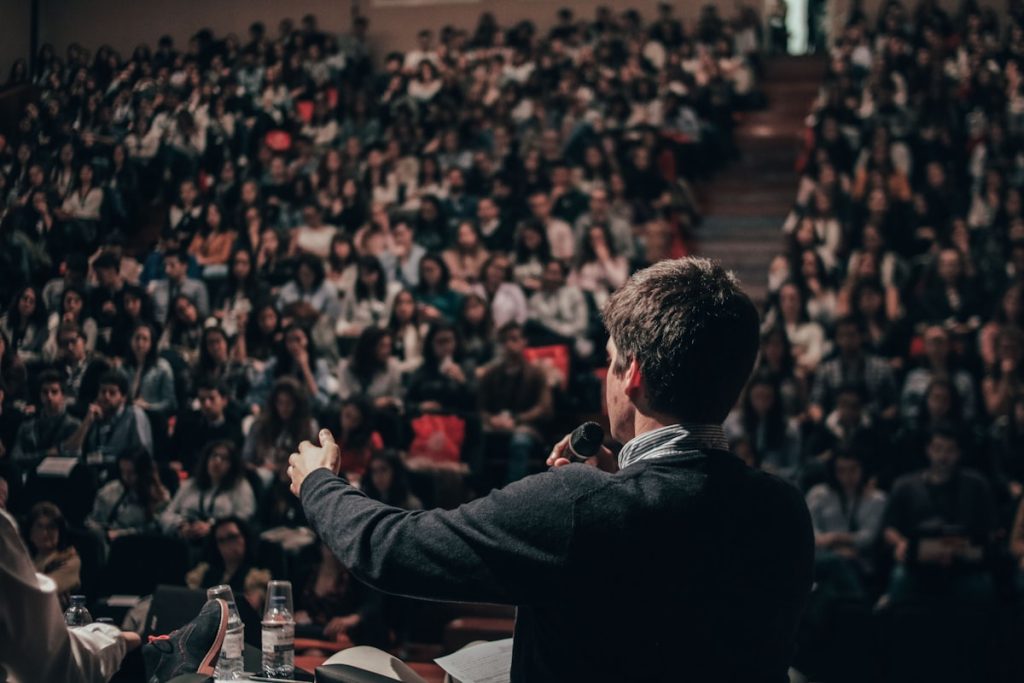 Man speaking in front of a crowd